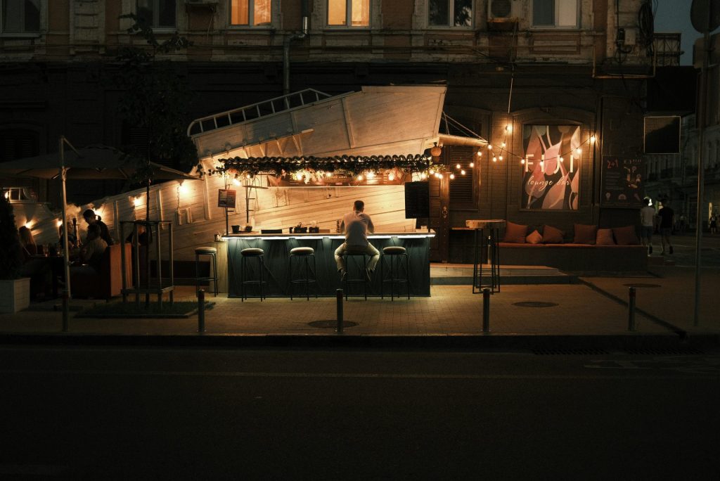 a man sitting at a bar in front of a building